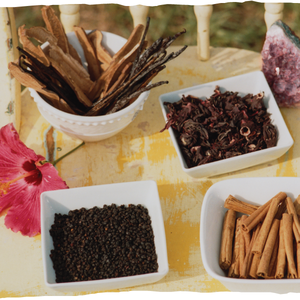 Ingredients arranged on a table. the ingredients are organic, wild fruits, herbal extracts, botanicals and amethyst crystal
